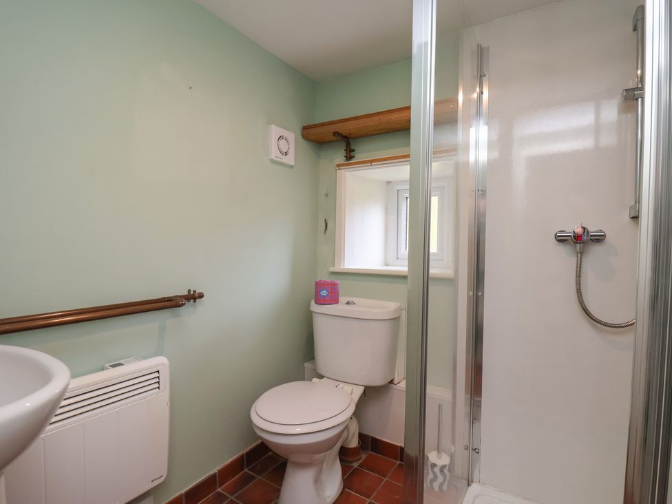 A bathroom with a shower, toilet, and sink at Apartment at Mulgrave House Hinderwell near Staithes
