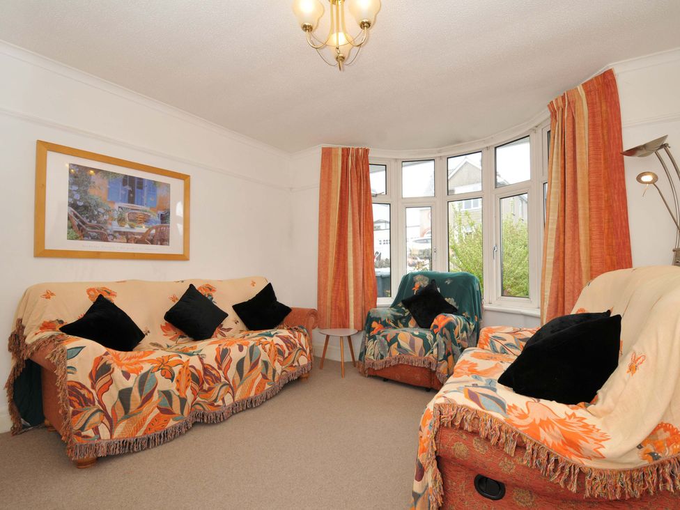A living room with sofa and armchairs at Porthmeor in Wadebridge