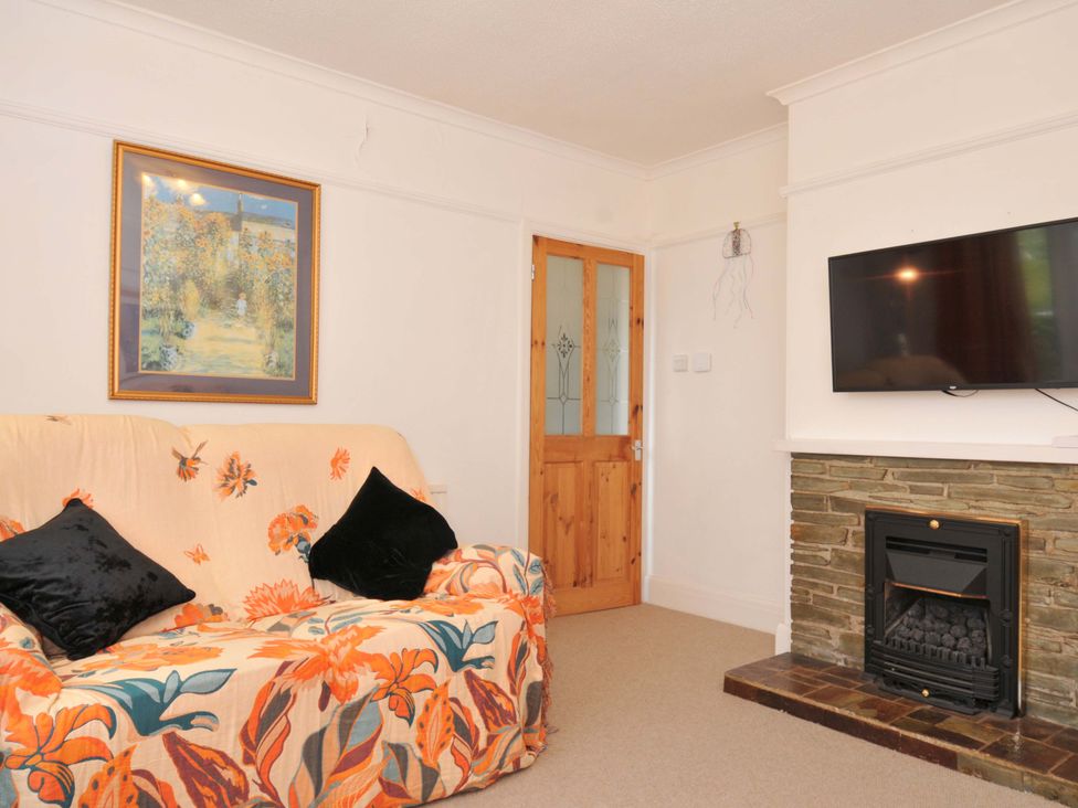 A living room with a sofa and television at Porthmeor in Wadebridge