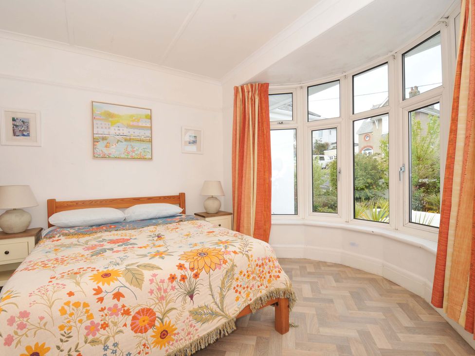 A bedroom with a bed and a window at Porthmeor Wadebridge