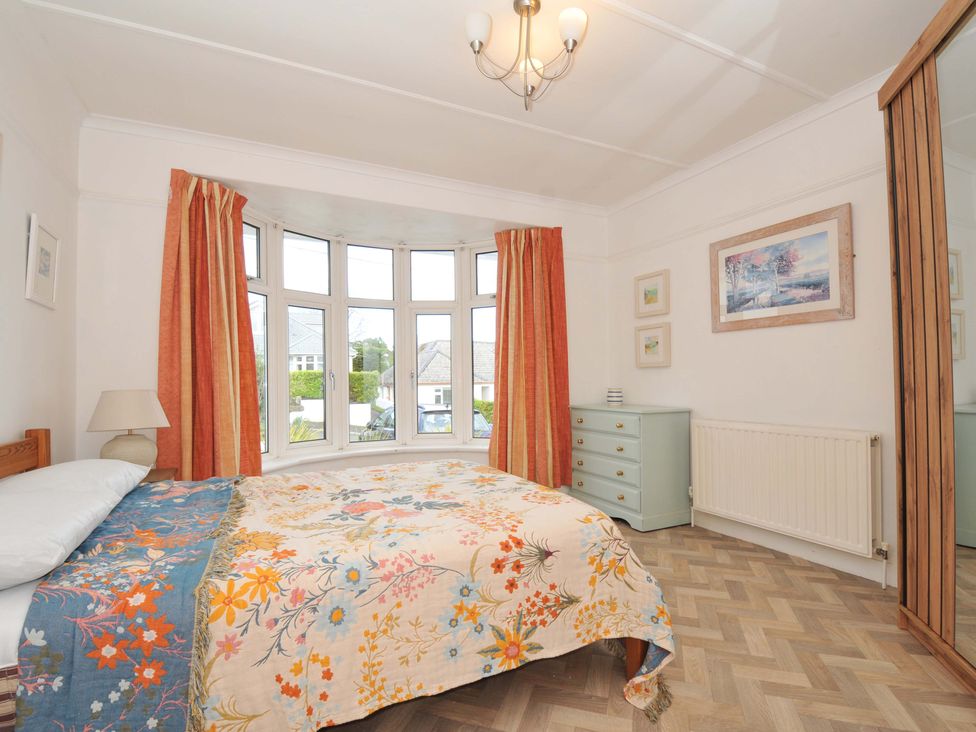A bedroom with a bed and a chest of drawers at Porthmeor in Wadebridge