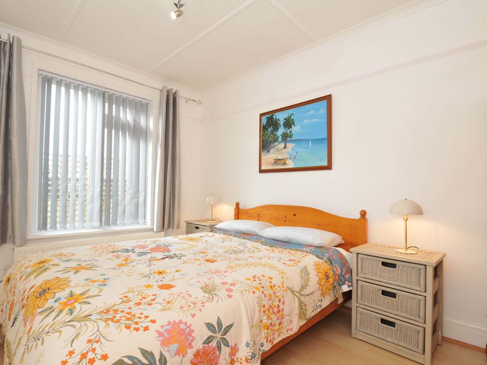 A bedroom featuring a bed and bedside table at Porthmeor Wadebridge