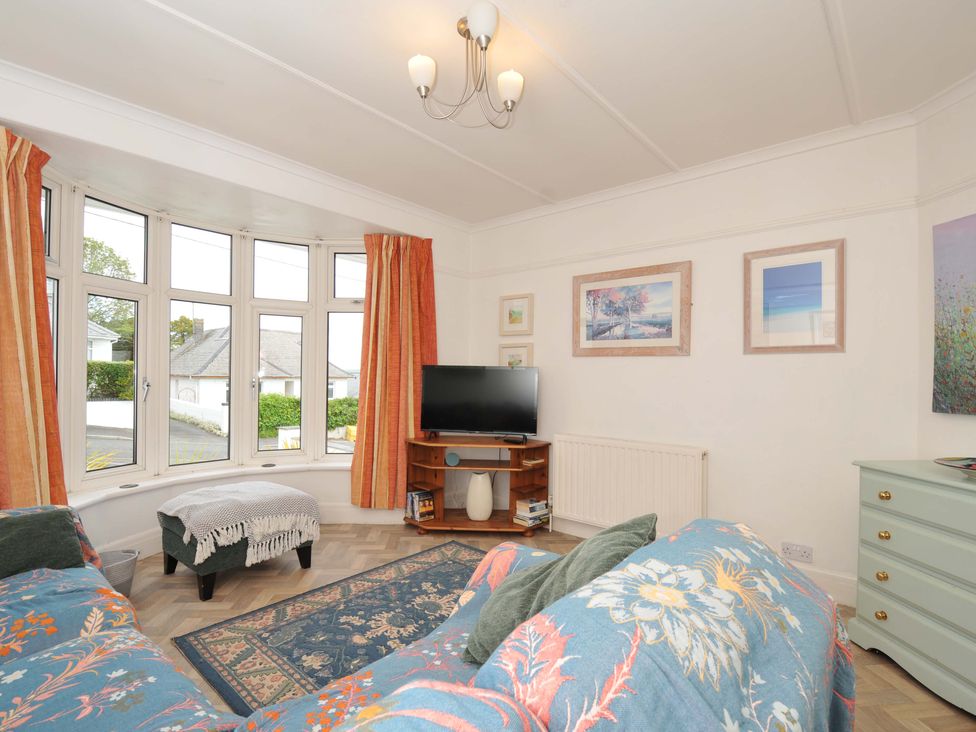 A living room with a TV and sofa at Porthmeor in Wadebridge