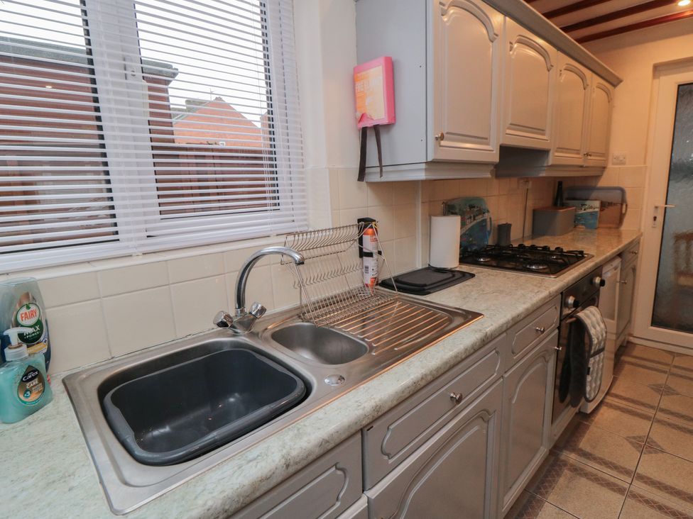 A kitchen with a sink and stove at Seabreeze in Filey