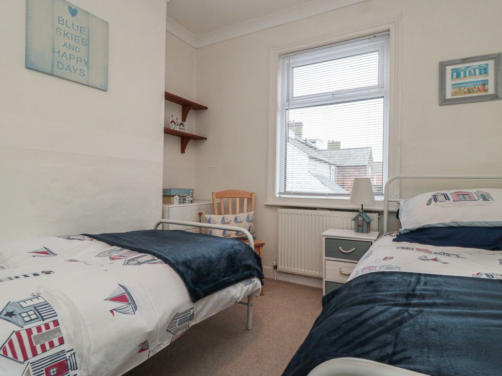 A bedroom with two beds and a window at Seabreeze in Filey