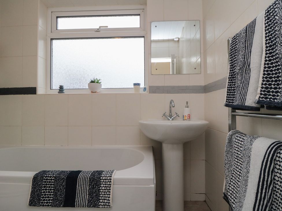 A bathroom with a bathtub and sink at Seabreeze in Filey