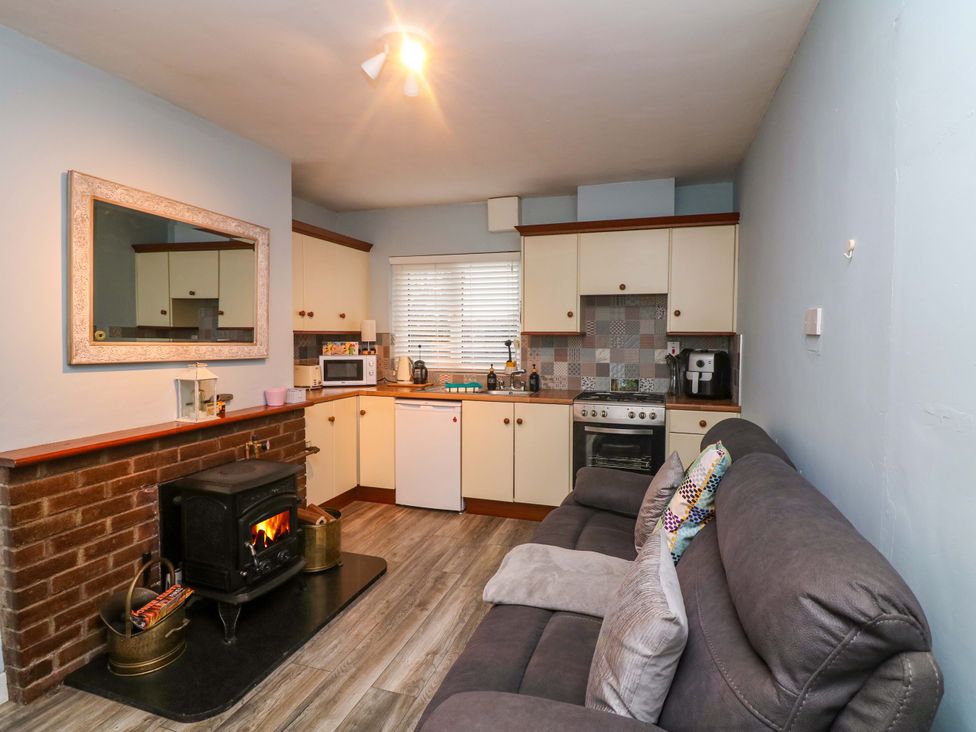 A kitchen with a stove, microwave, and refrigerator at Long Jack's Ballygarrett, County Wexford