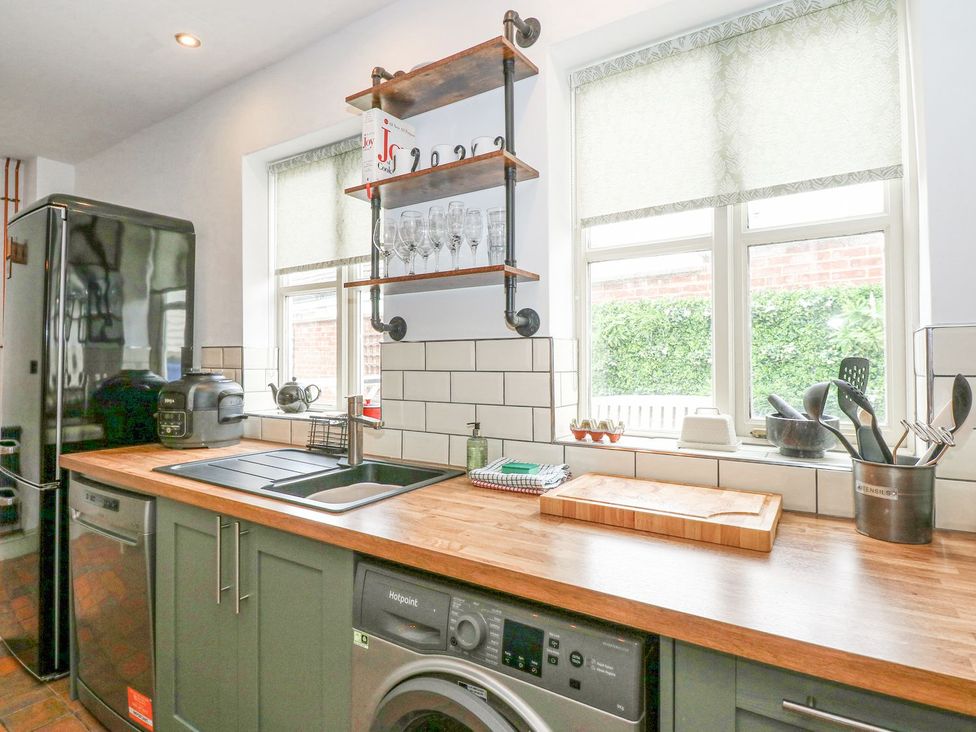 A kitchen with appliances and utensils at Joy's Cottage Snettisham