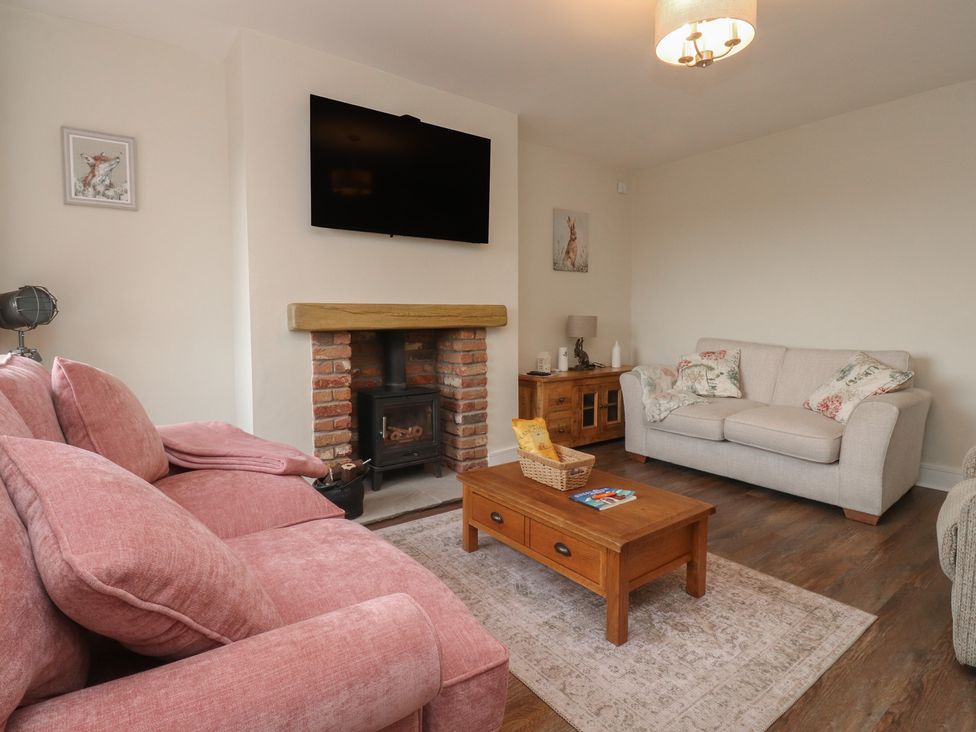 A living room with a sofa and fireplace at Wardenlea in Preston