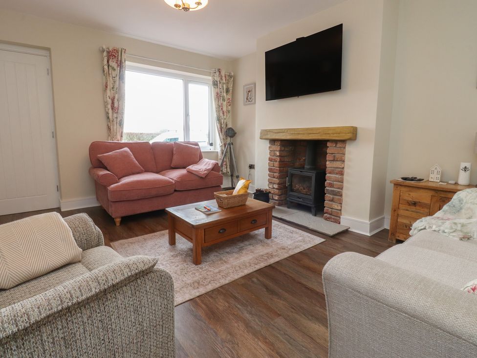 A living room with a sofa and coffee table at Wardenlea in Preston