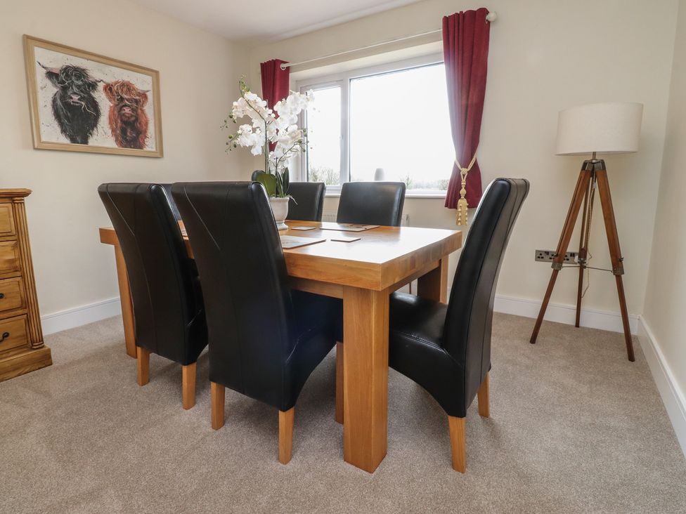 A dining room with a table and six chairs at Wardenlea in Preston