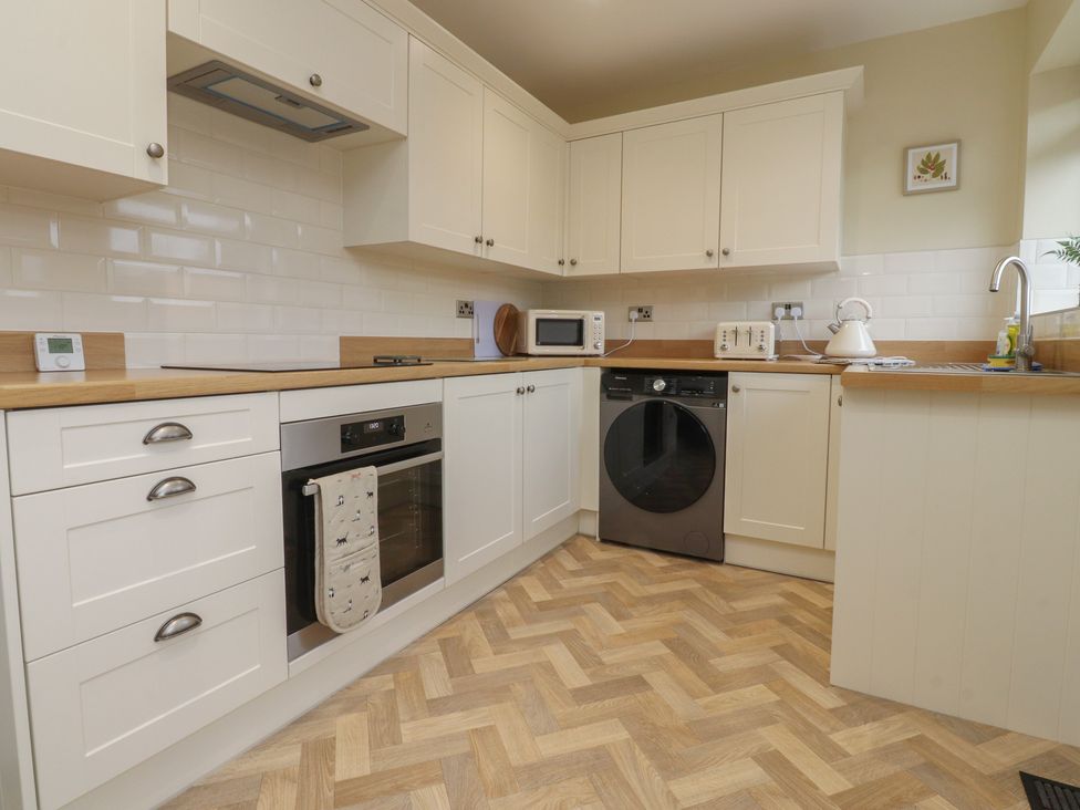 A kitchen with cabinets and appliances at Wardenlea Preston