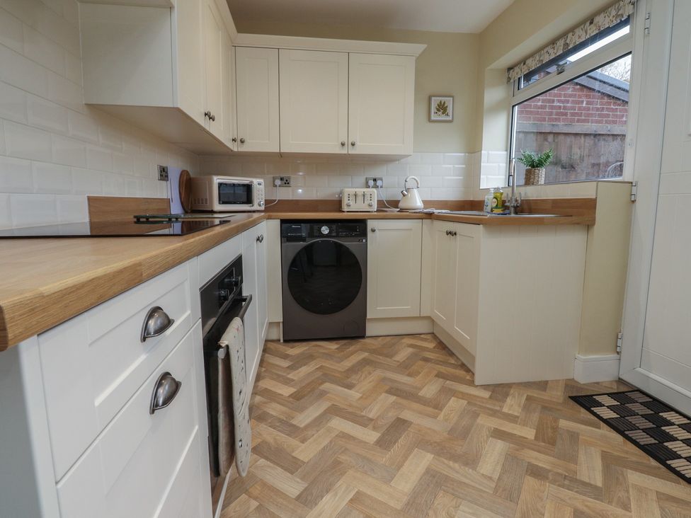 A kitchen with appliances and countertops at Wardenlea in Preston