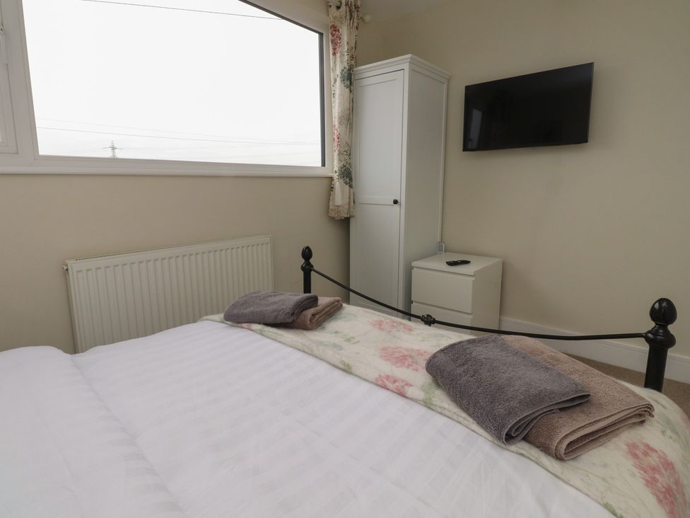 A bedroom with a bed and towels on it at Wardenlea in Preston