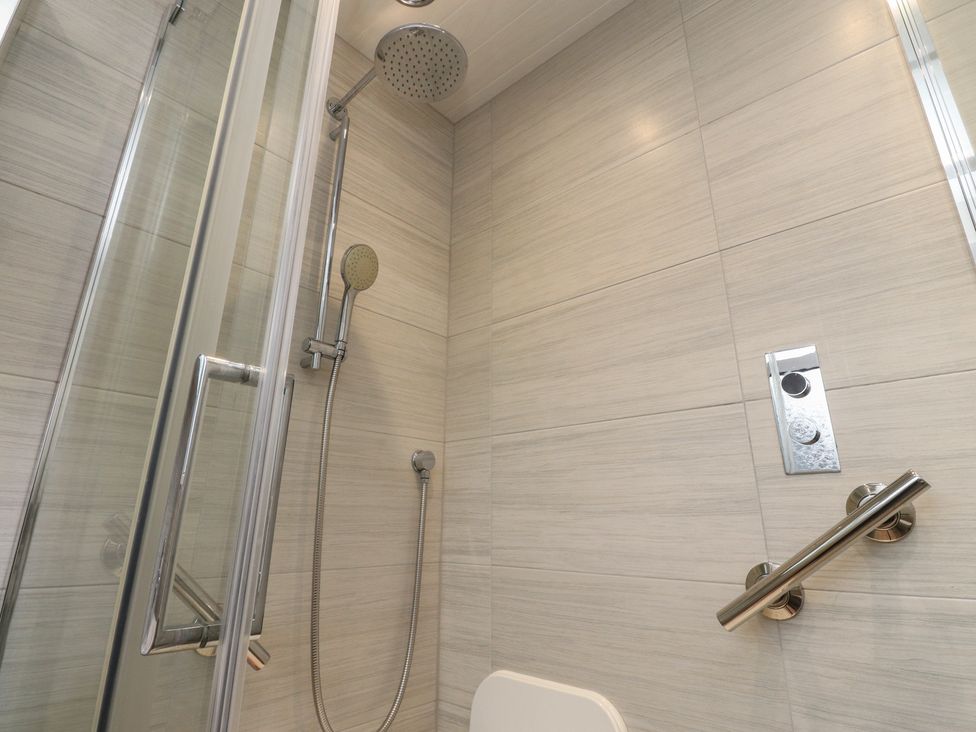 A bathroom with a shower and toilet at Wardenlea in Preston