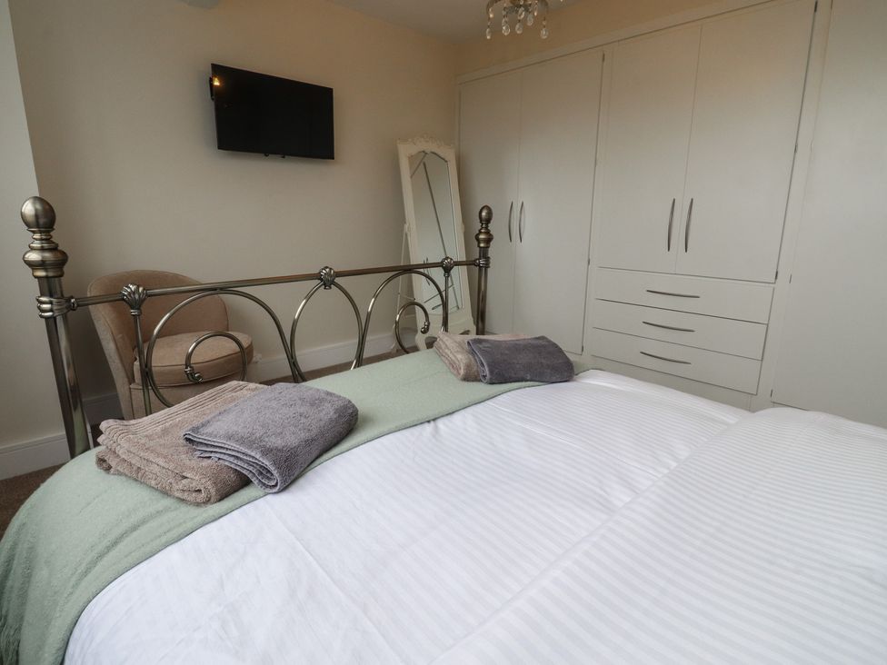 A bedroom with a bed and wardrobe at Wardenlea in Preston