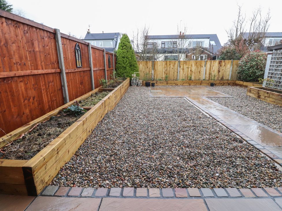 A garden with gravel and wooden garden beds at Wardenlea Preston