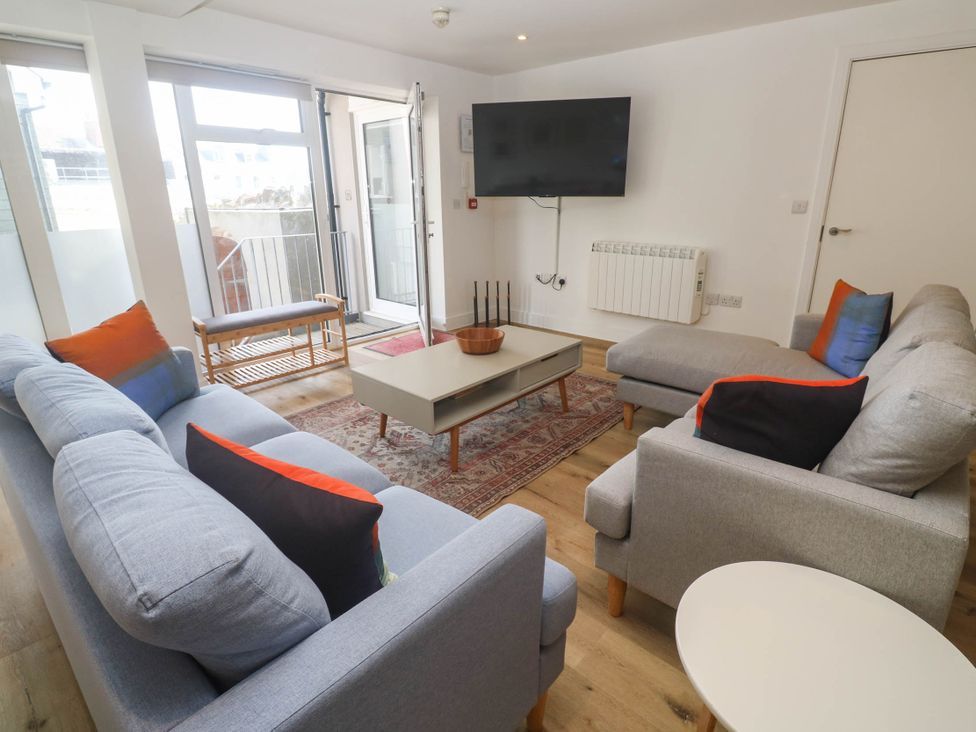 A living room with a sofa and coffee table at 11 Fountain Court Falmouth