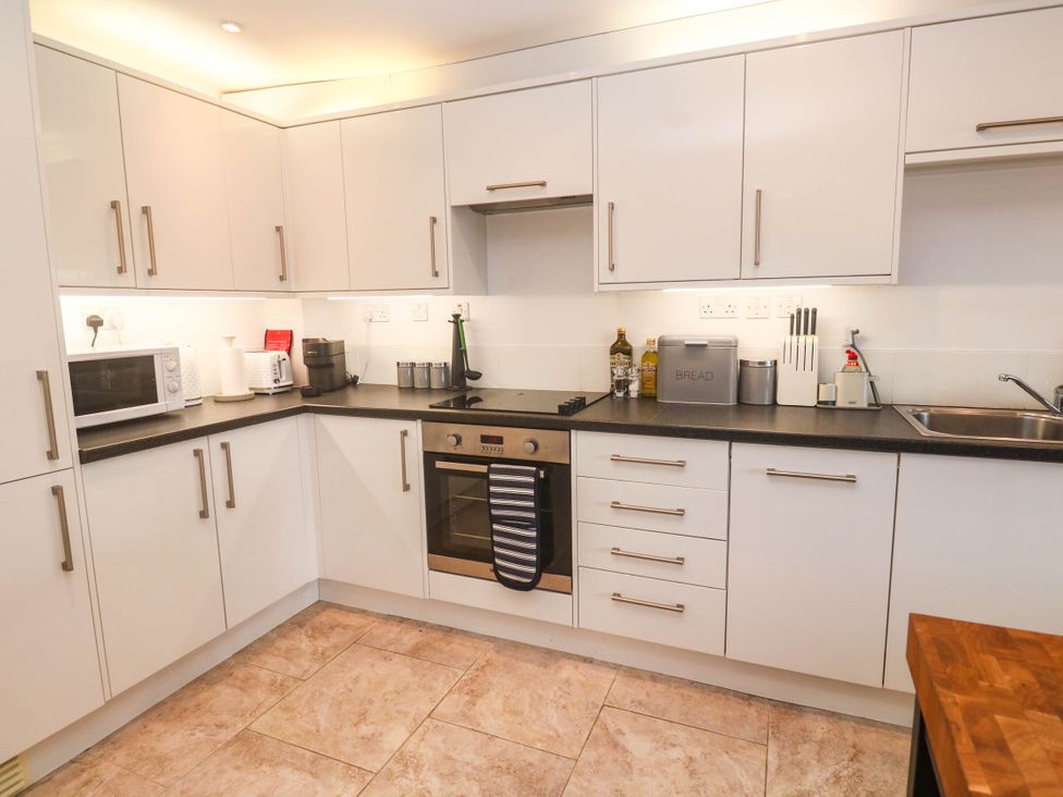 A kitchen with appliances and storage at 11 Fountain Court in Falmouth