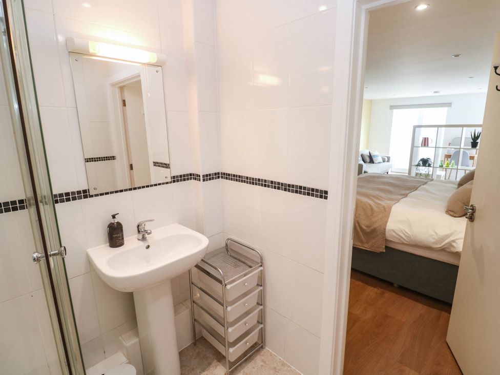 A bathroom featuring a sink and shower at 11 Fountain Court in Falmouth