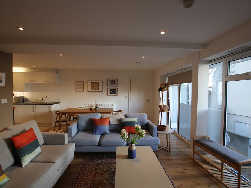 A living room with a sofa and coffee table at 11 Fountain Court in Falmouth
