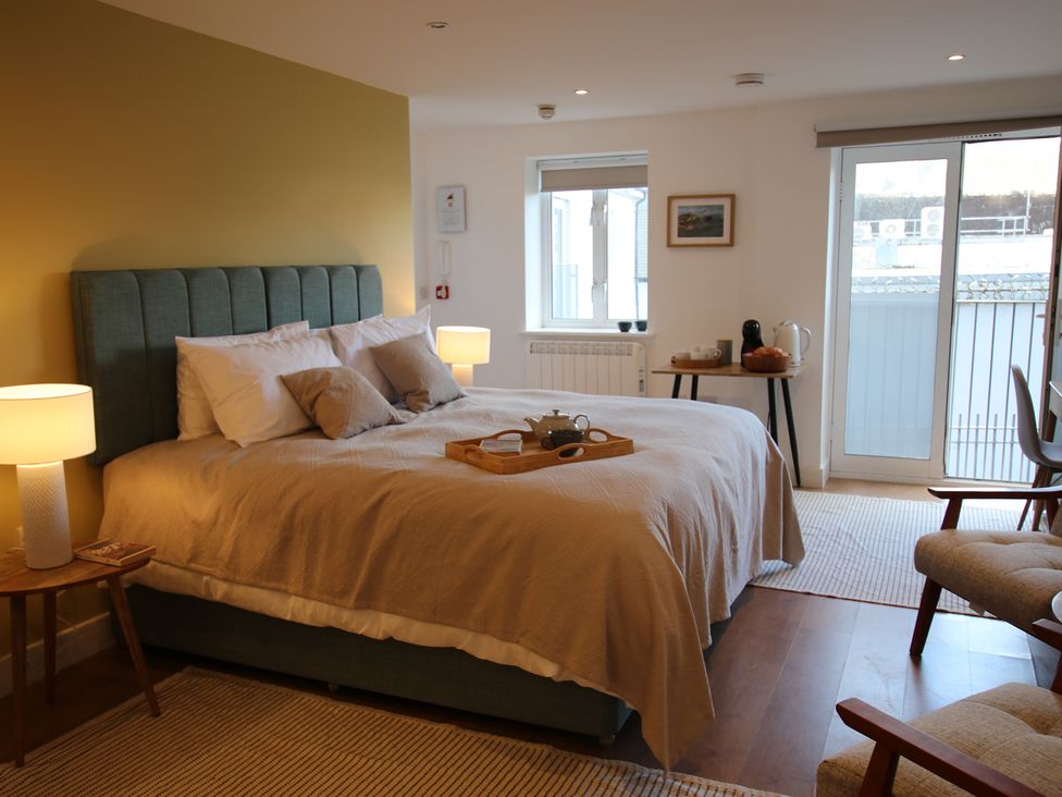 A bedroom with a bed and a tray on it at 11 Fountain Court in Falmouth