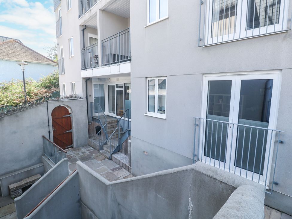 An outdoor area with a staircase leading to a balcony at 11 Fountain Court in Falmouth