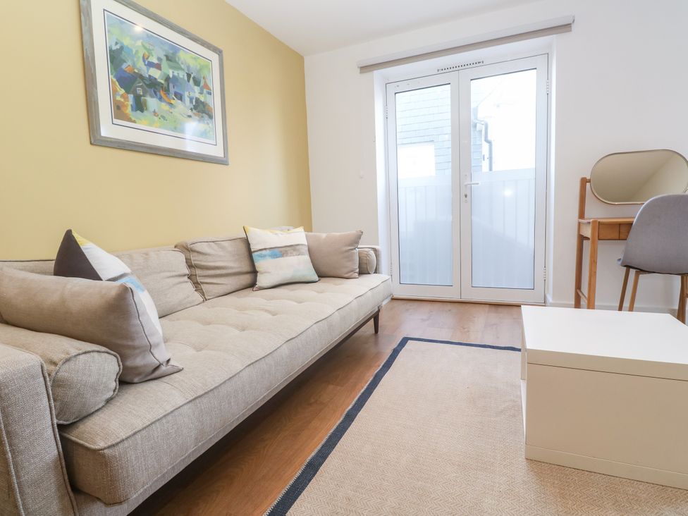 A living room with a sofa and table at 11 Fountain Court in Falmouth