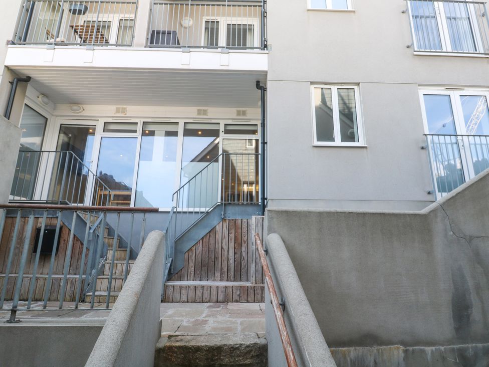 An outdoor view of stairs leading to a balcony at 11 Fountain Court in Falmouth
