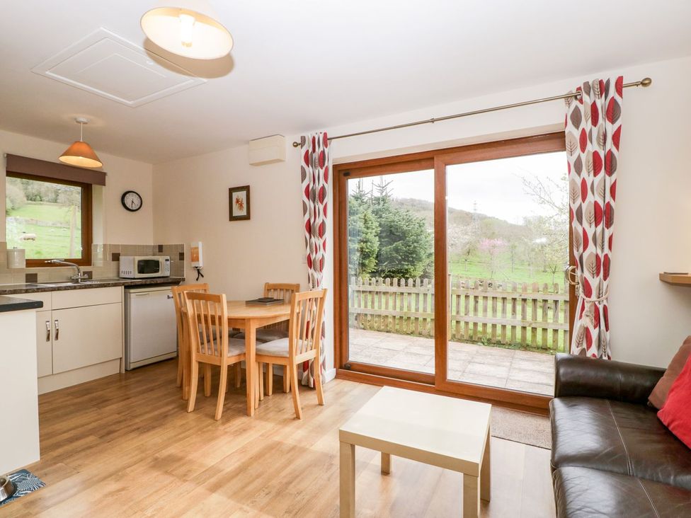 A kitchen with a table and chairs at Orchard Cottage in Ledbury