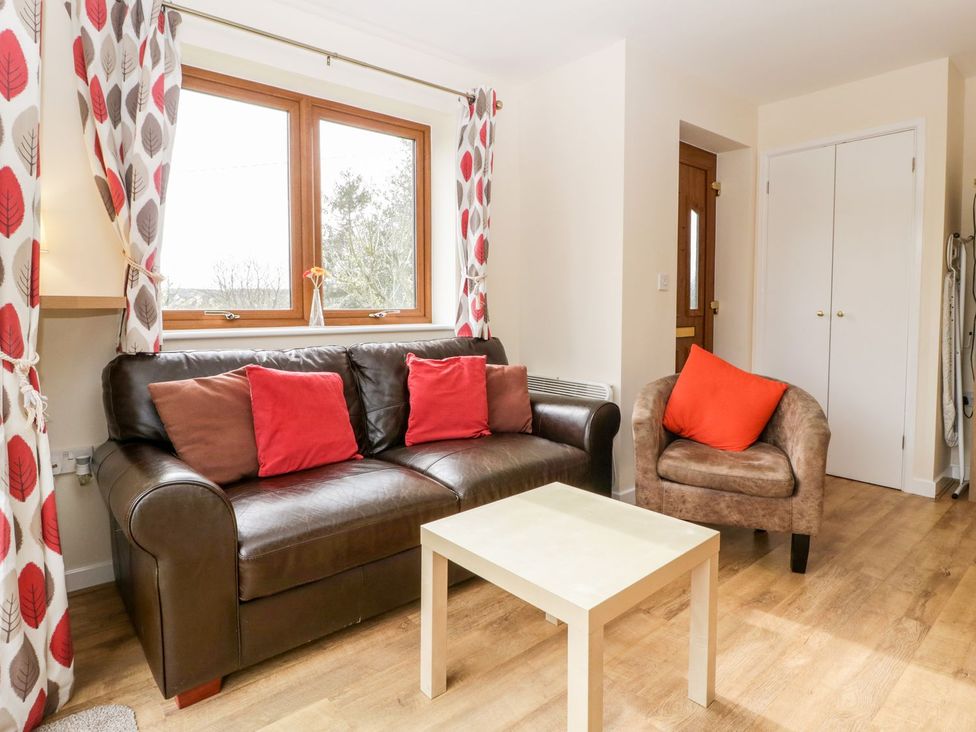 A living room with a sofa and coffee table at Orchard Cottage in Ledbury