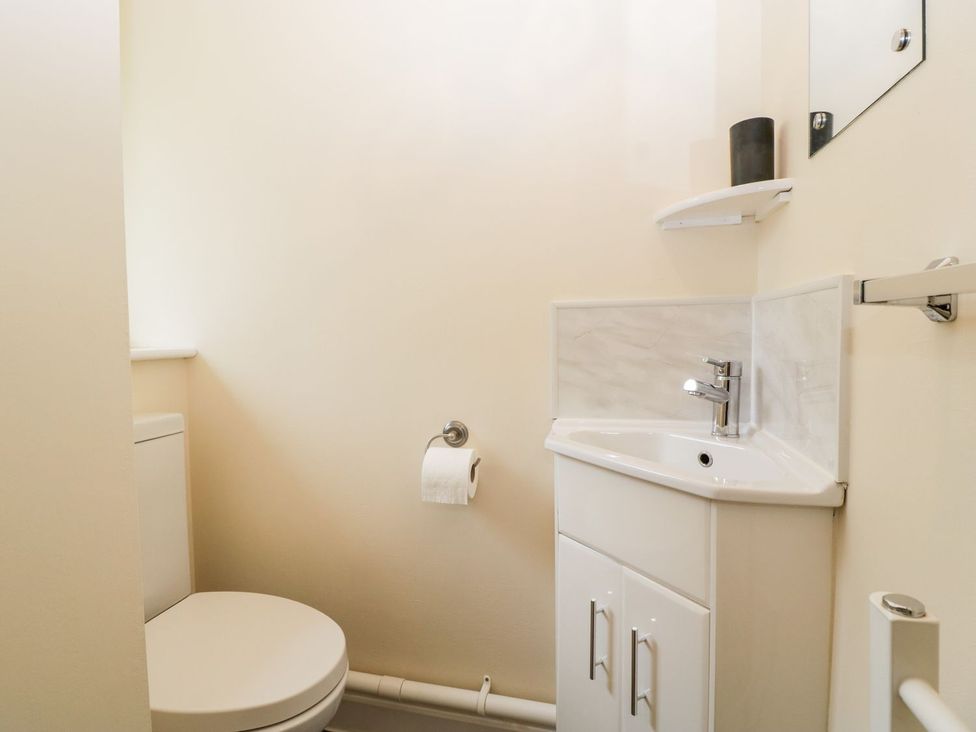 A bathroom with a toilet and sink at Orchard Cottage in Ledbury