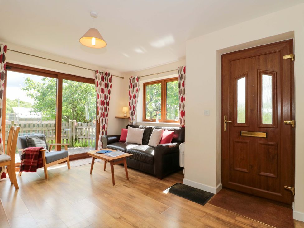 A living room with a sofa and table at Orchard Cottage in Ledbury
