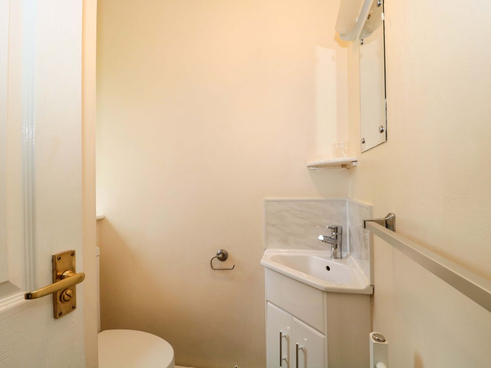 A bathroom with a toilet and sink at Orchard Cottage in Ledbury