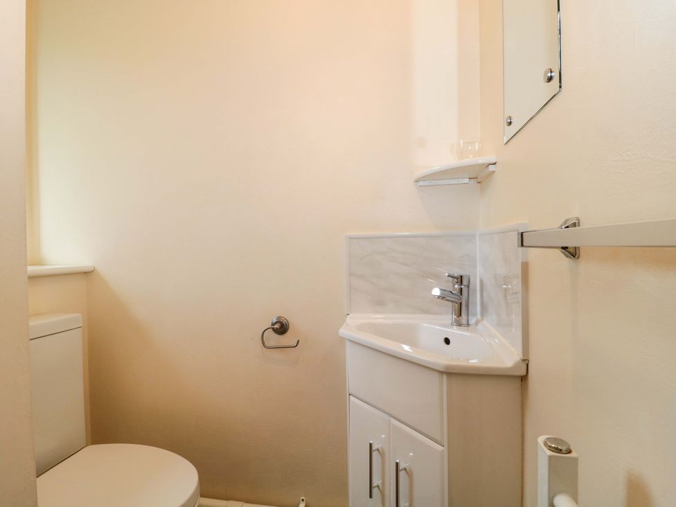 A bathroom with a toilet and sink at Orchard Cottage in Ledbury