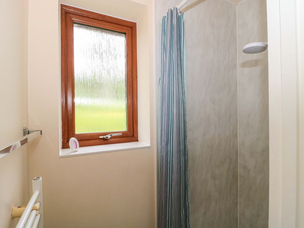 A bathroom with a shower and window at Orchard Cottage in Ledbury