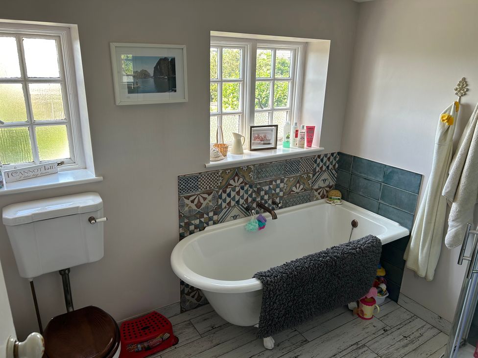A bathroom with a bathtub and a toilet at Somerby in St. Bees