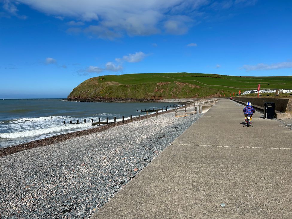 A child riding a bicycle along a coastal pathway at Somerby in St. Bees