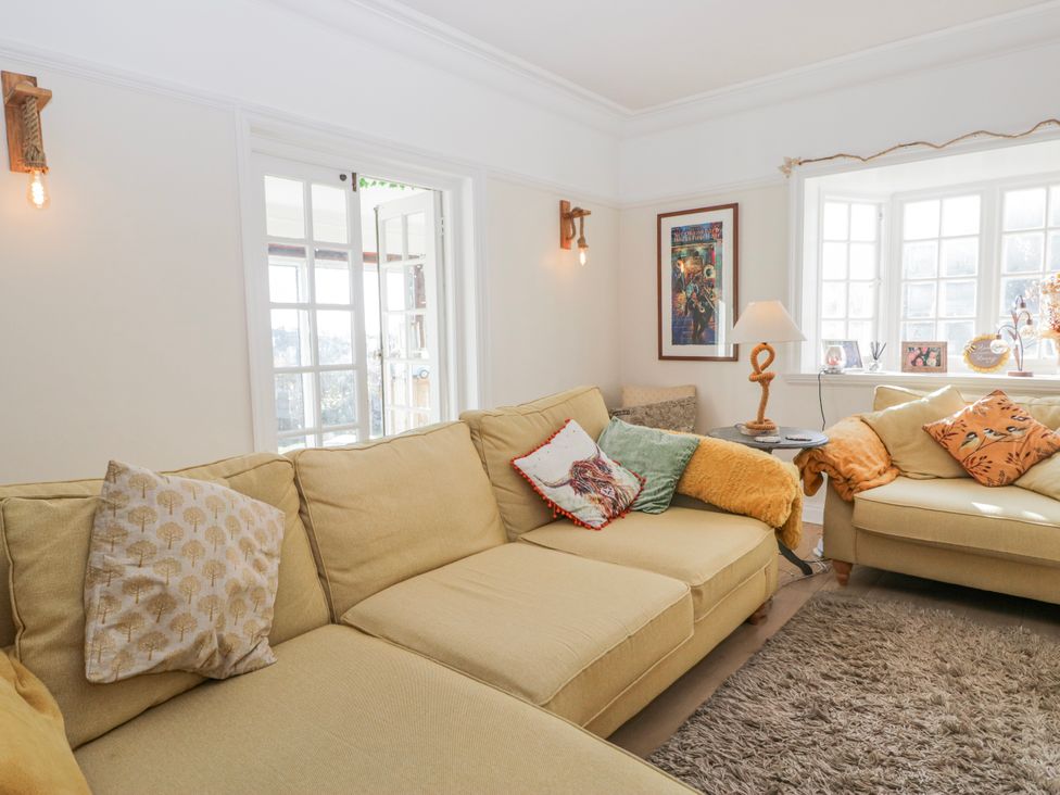 A living room with a sofa and table at Somerby St Bees