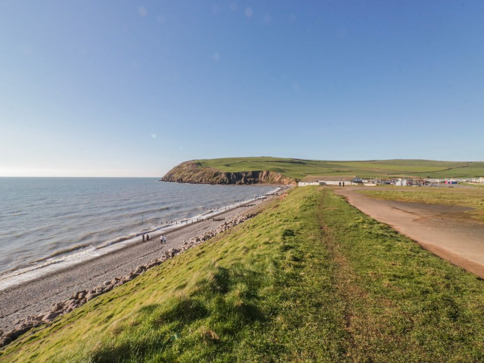 A beach along the ocean with a pathway in the background at Somerby in St Bees