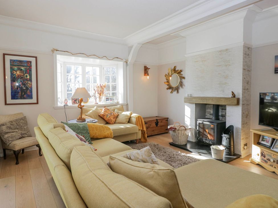 A living room with a sofa and fireplace at Somerby in St Bees