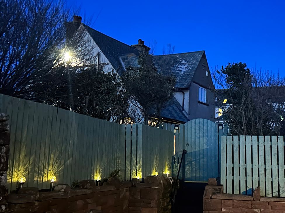 A garden view featuring a house and gate at Somerby in St Bees