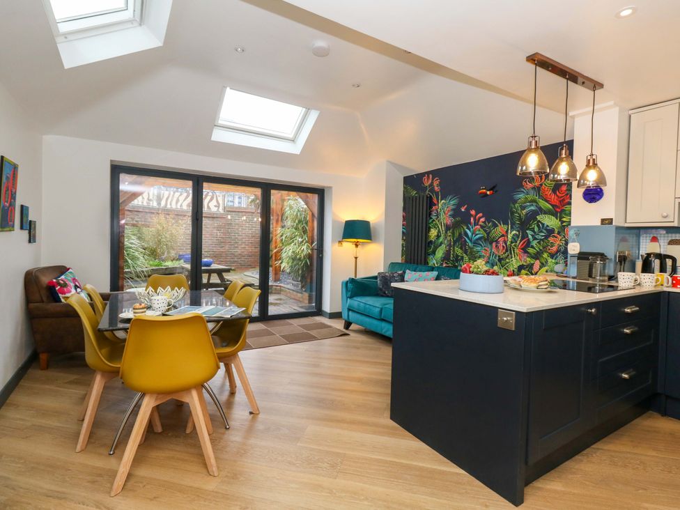 A kitchen with dining table and chairs at Still Waters in Weymouth