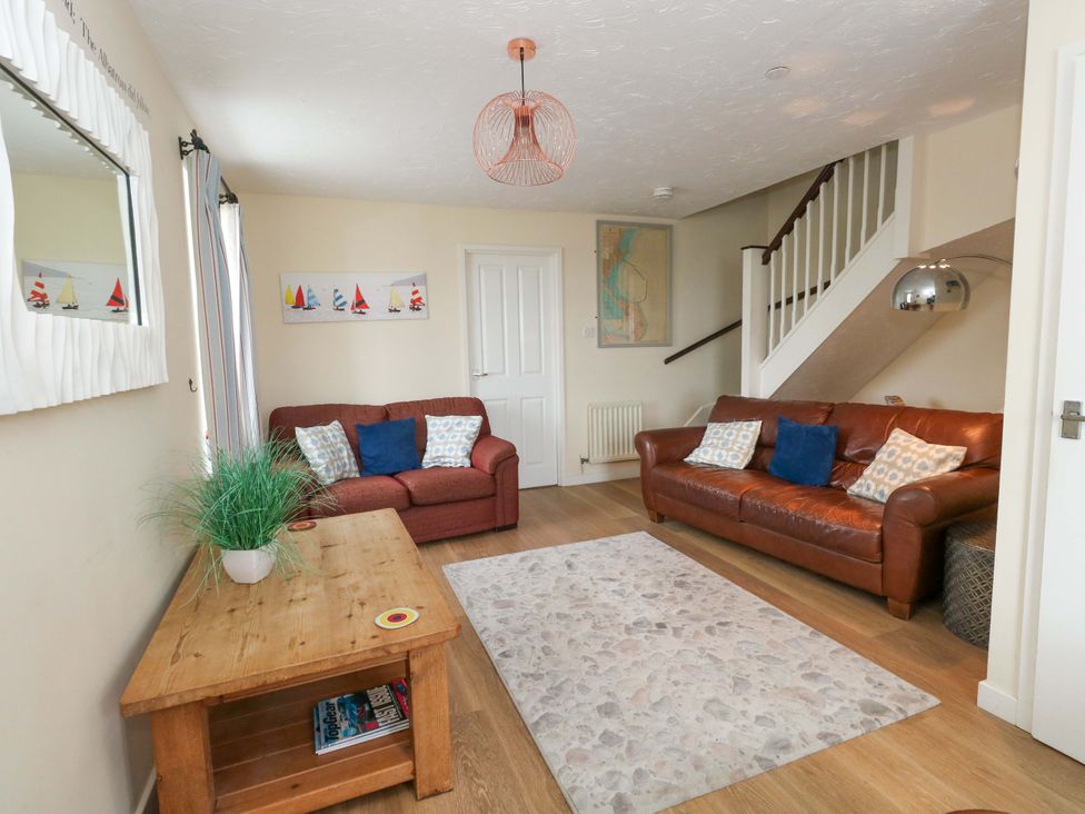 A living room with sofas and a coffee table at Still Waters in Weymouth