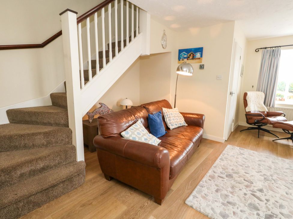 A living room featuring a sofa and armchair at Still Waters in Weymouth
