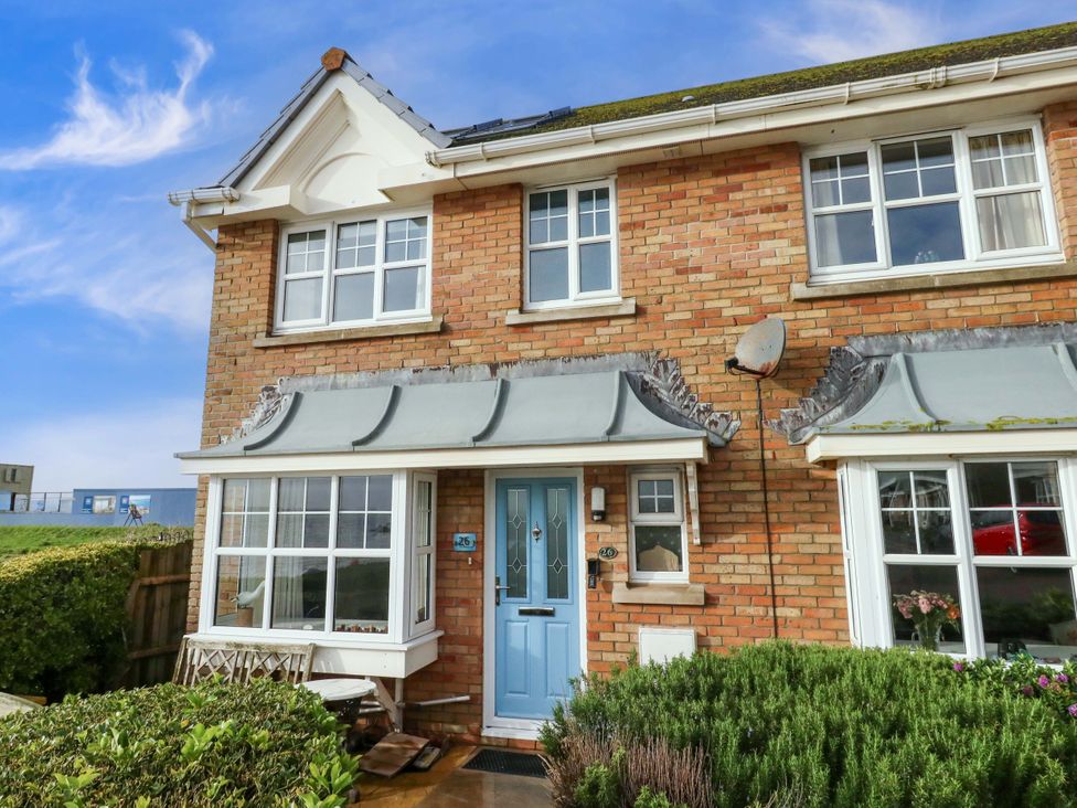 A house with a blue door and garden at Still Waters in Weymouth