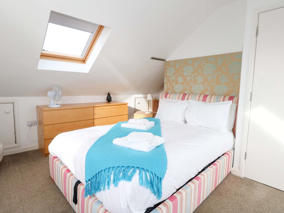 A bedroom with a bed and furniture at Still Waters in Weymouth