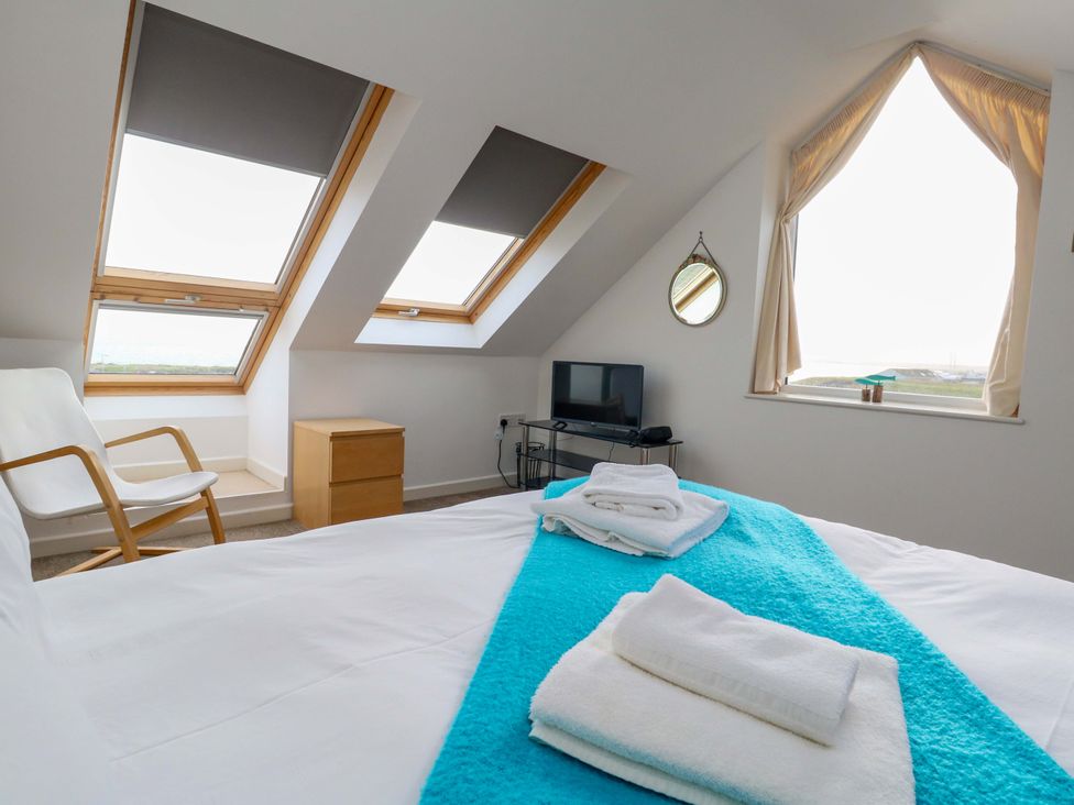 A bedroom with a bed and a television at Still Waters in Weymouth
