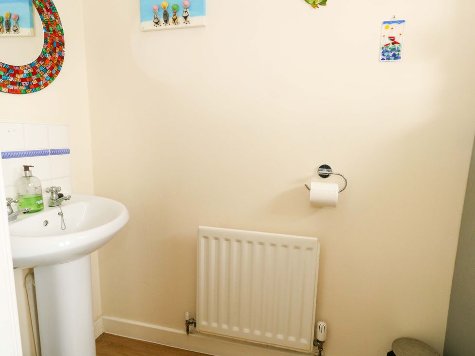 A bathroom featuring a sink and a radiator at Still Waters in Weymouth
