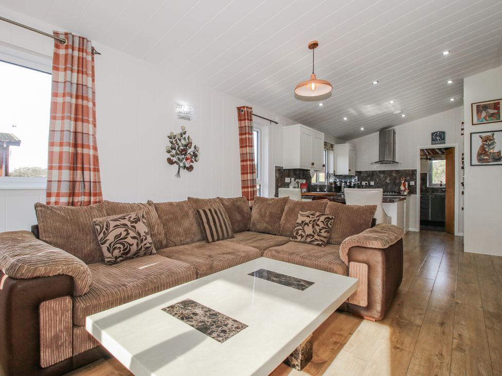 A living room featuring a sofa and coffee table at Hazel Lodge in Clunton near Clun